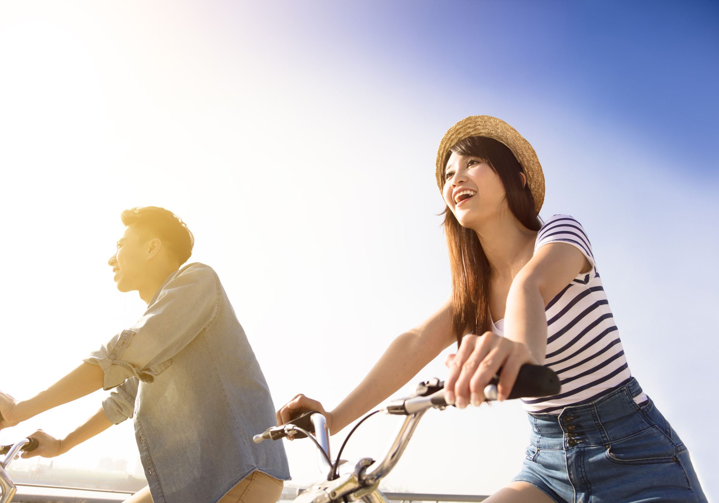 50480646 - happy young couple going for  bicycle ride on a sunny day